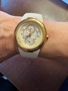 PHILIP STEIN gold bezel watch with white rubber strap (needs new battery)